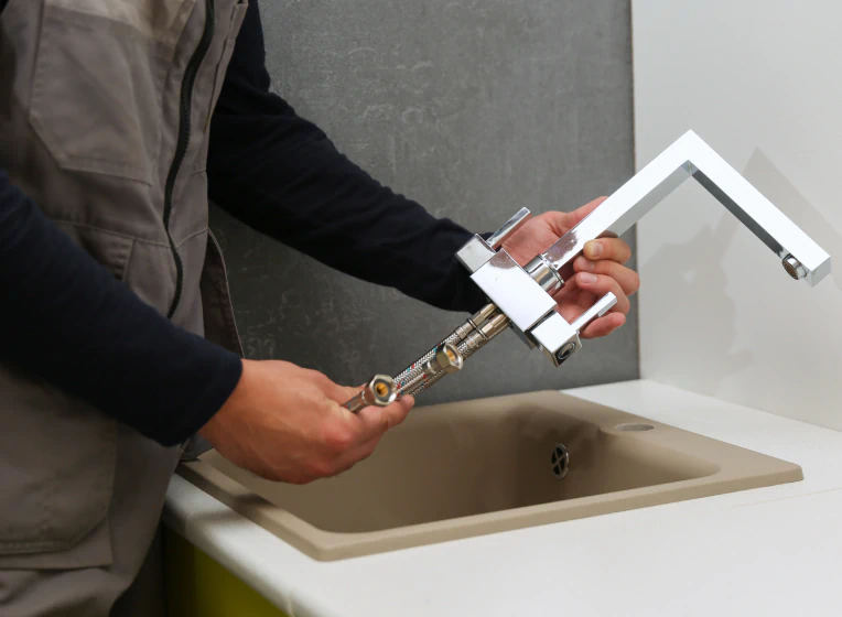 worker installing faucet
